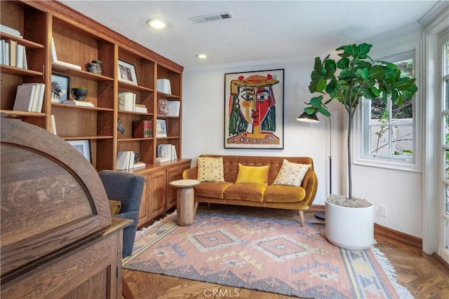 sitting room with crown molding, baseboards, wood finished floors, and recessed lighting