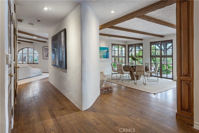 hall featuring dark wood finished floors, beam ceiling, and recessed lighting