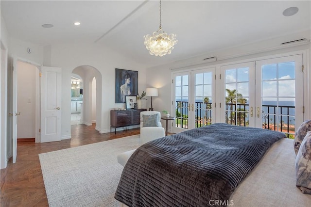 bedroom featuring arched walkways, french doors, vaulted ceiling, access to exterior, and baseboards