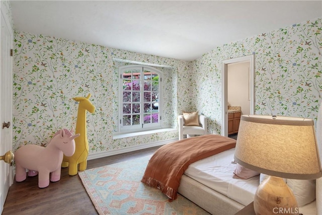 sitting room featuring wallpapered walls, wood finished floors, and baseboards