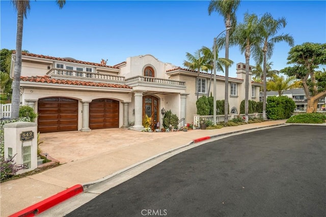 842 Harbor Island Dr, Newport Beach, CA 92660 - mediterranean / spanish house with stucco siding, concrete driveway, a garage, a balcony, and a tile roof