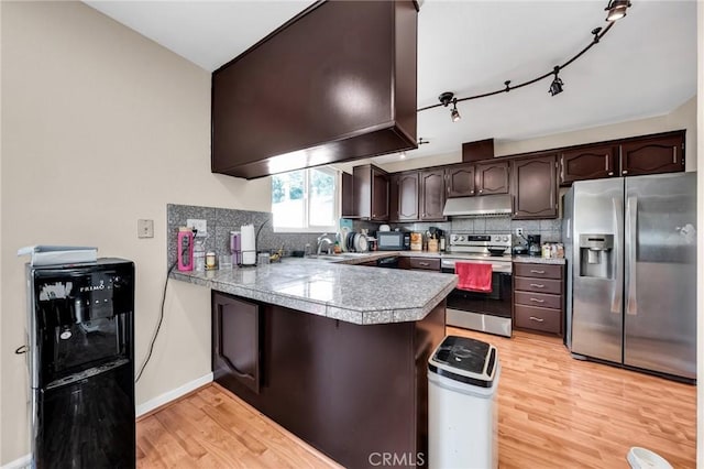 3862 Pimlico Dr, Pleasanton, CA 94588 - kitchen featuring black appliances, under cabinet range hood, a peninsula, dark brown cabinets, and light wood finished floors