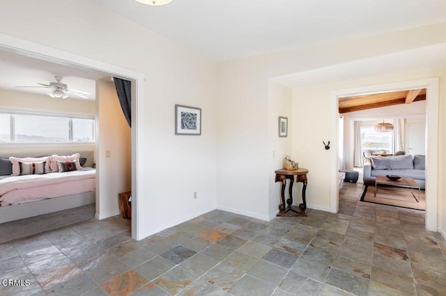 bedroom featuring stone finish flooring and baseboards