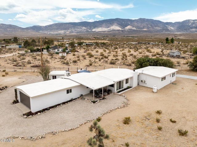 aerial view of sparsely populated area with a desert landscape and mountains