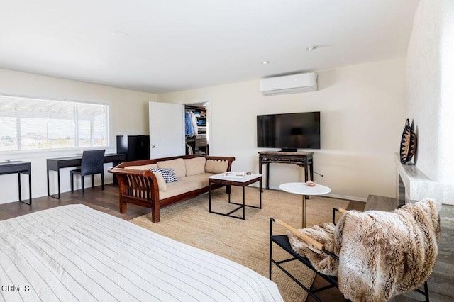 living area with a wall unit AC and baseboards