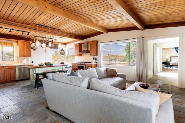 living area featuring stone tile floors, beam ceiling, and wood ceiling