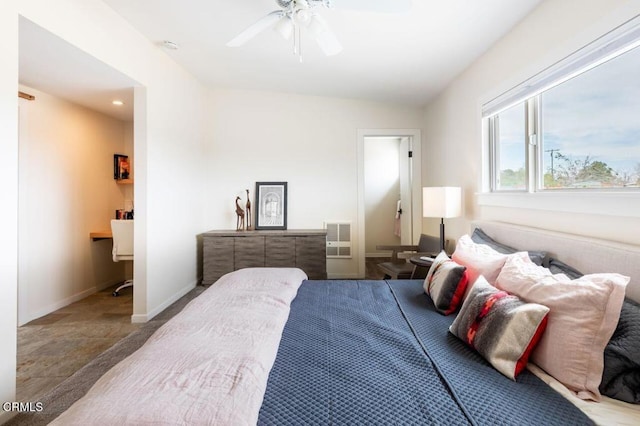 bedroom featuring stone finish flooring, baseboards, and ceiling fan