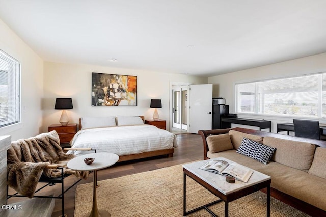 bedroom featuring multiple windows and wood finished floors