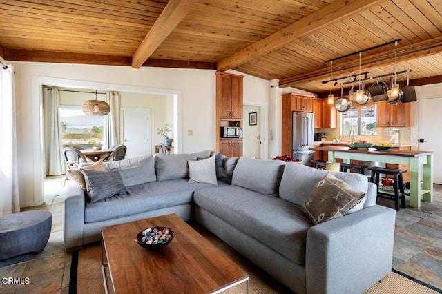 living area featuring wood ceiling and stone finish floors