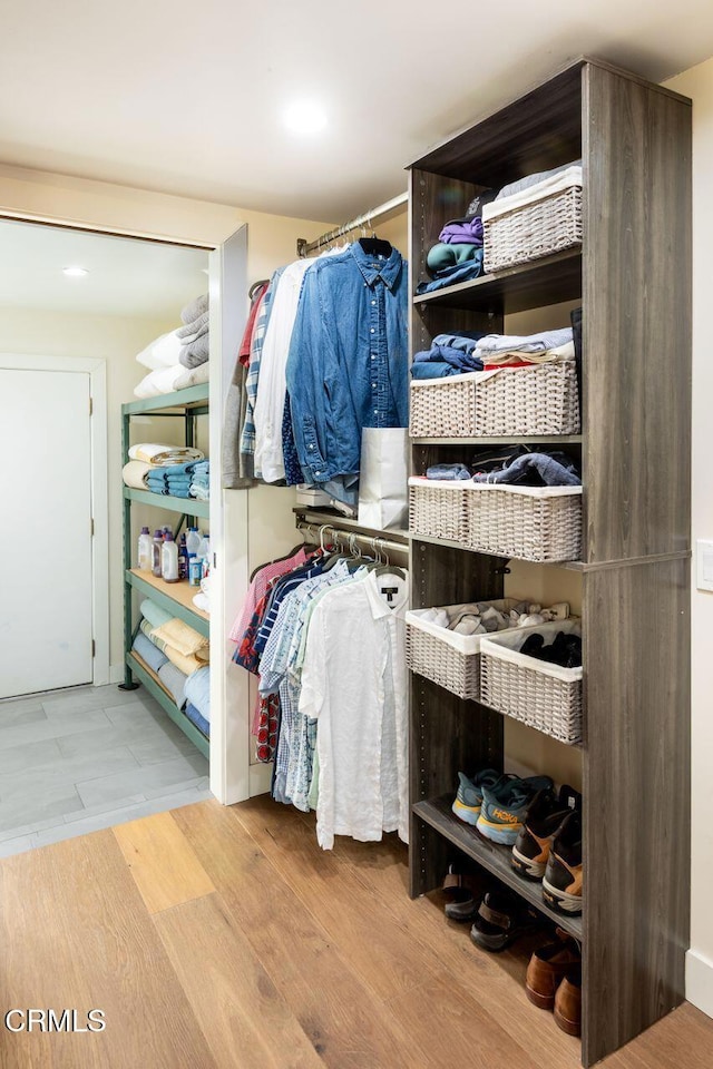 walk in closet featuring wood finished floors