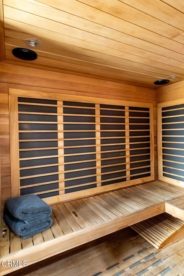 sauna with wooden ceiling and wood-type flooring