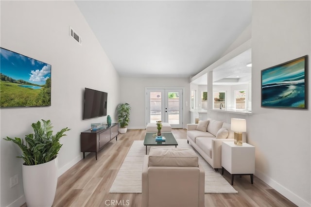 1032 Glenn Ct, Lancaster, CA 93535 - living room featuring light wood finished floors, baseboards, and french doors