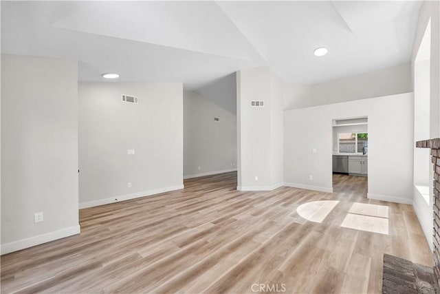 1032 Glenn Ct, Lancaster, CA 93535 - unfurnished living room featuring light wood-style flooring, baseboards, lofted ceiling, and recessed lighting