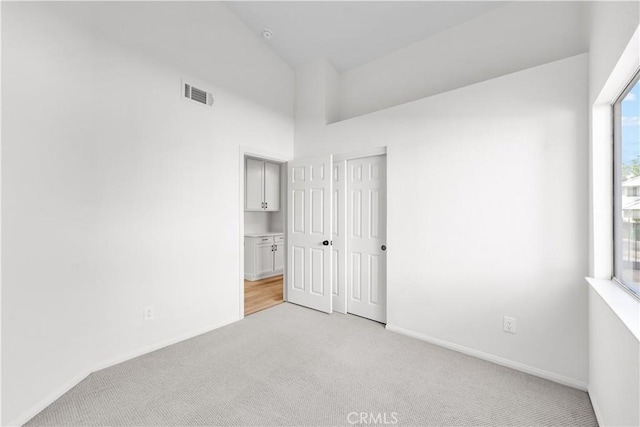 1032 Glenn Ct, Lancaster, CA 93535 - unfurnished bedroom featuring light carpet, baseboards, a high ceiling, and a closet