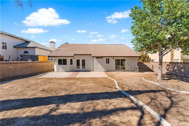1032 Glenn Ct, Lancaster, CA 93535 - back of house featuring french doors, stucco siding, a fenced backyard, and a patio area