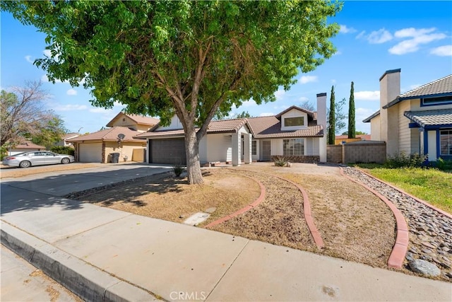 1032 Glenn Ct, Lancaster, CA 93535 - view of front of house featuring driveway, an attached garage, fence, a tiled roof, and a chimney