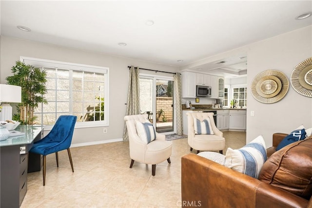living area featuring baseboards and light tile patterned flooring