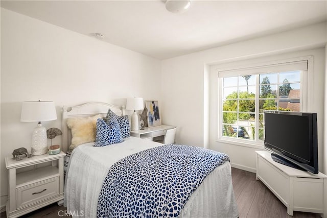 bedroom featuring dark wood-style flooring and baseboards