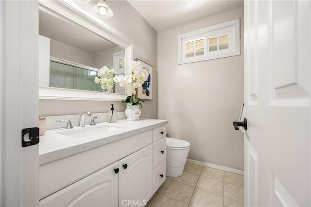 full bathroom featuring tile patterned flooring, baseboards, vanity, and toilet