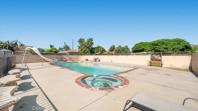 4536 N Irwindale Ave, Covina, CA 91722 - view of swimming pool featuring a water slide, a patio, fence, and a pool with connected hot tub