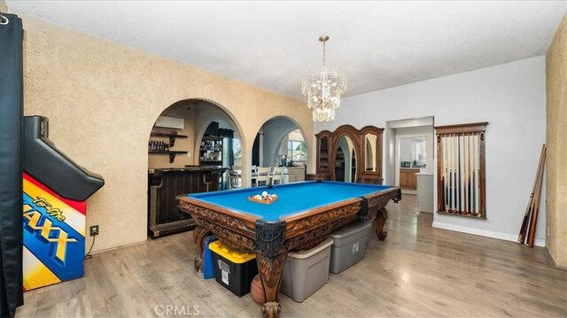 4536 N Irwindale Ave, Covina, CA 91722 - playroom featuring billiards table, a chandelier, wood finished floors, arched walkways, and a bar