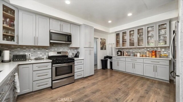 4536 N Irwindale Ave, Covina, CA 91722 - kitchen with appliances with stainless steel finishes, gray cabinets, decorative backsplash, light countertops, and wood finished floors
