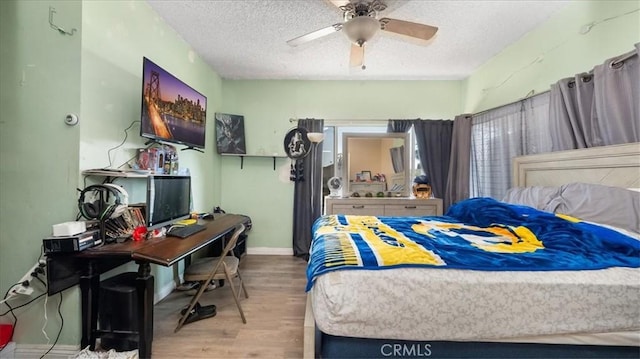 4536 N Irwindale Ave, Covina, CA 91722 - bedroom featuring wood finished floors, a textured ceiling, a desk, a ceiling fan, and baseboards