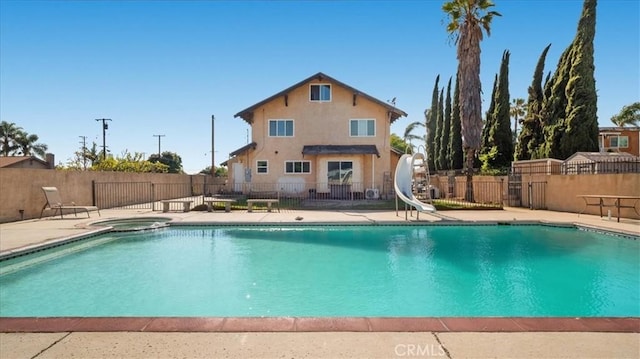 4536 N Irwindale Ave, Covina, CA 91722 - view of swimming pool with a water slide, fence, a patio, and a pool with connected hot tub
