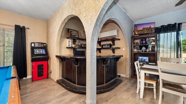 4536 N Irwindale Ave, Covina, CA 91722 - indoor dry bar featuring a textured ceiling, lofted ceiling, wood finished floors, and an AC wall unit