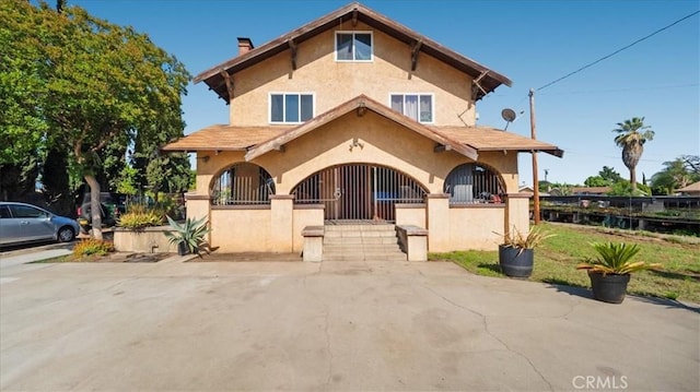 4536 N Irwindale Ave, Covina, CA 91722 - mediterranean / spanish house featuring stucco siding and a fenced front yard