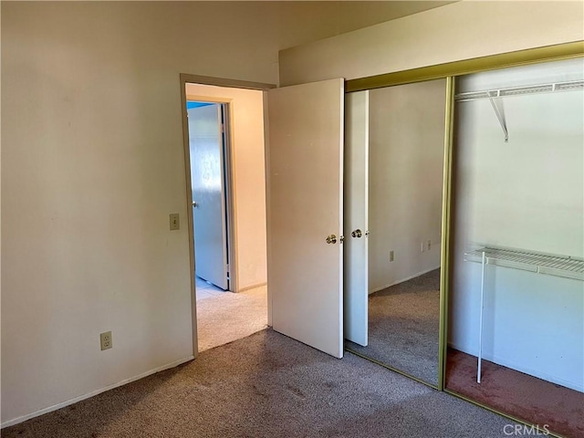 unfurnished bedroom featuring carpet floors and a closet
