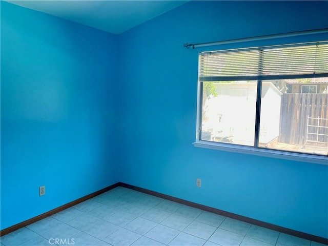 unfurnished room featuring baseboards