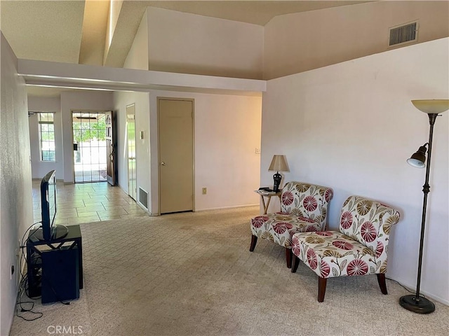 living area with carpet flooring, baseboards, and lofted ceiling