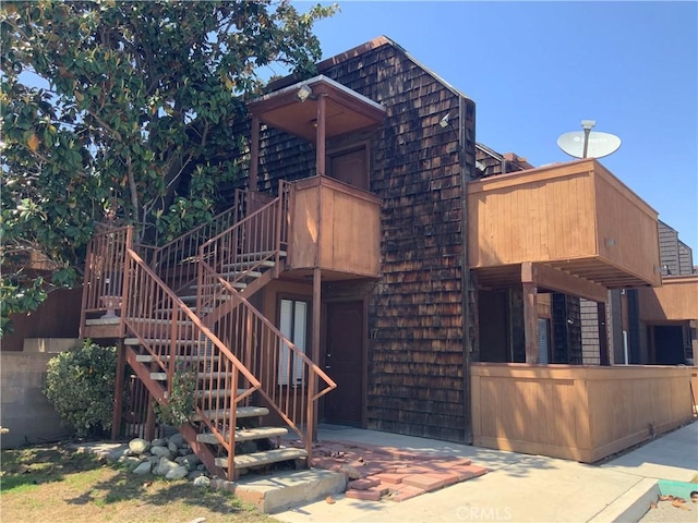 exterior space featuring stairs and a balcony