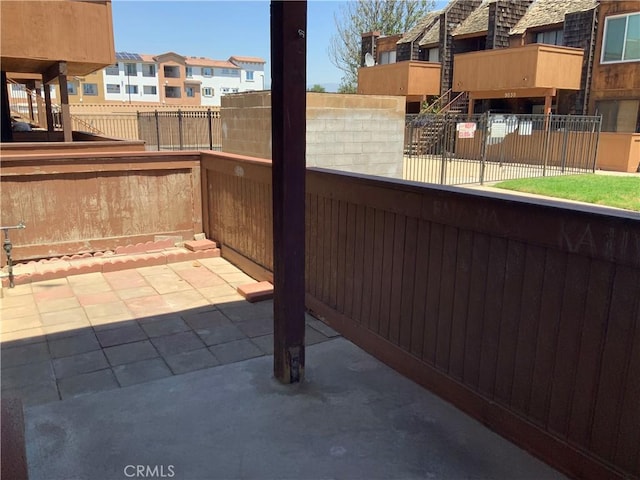 view of patio / terrace with fence and a residential view