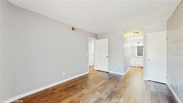 9020 Newport Ave Unit 17, Fontana, CA 92335 - unfurnished bedroom featuring hardwood / wood-style flooring, baseboards, and ensuite bathroom