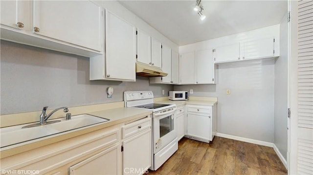 9020 Newport Ave Unit 17, Fontana, CA 92335 - kitchen with white appliances, under cabinet range hood, a sink, dark wood-style floors, and baseboards