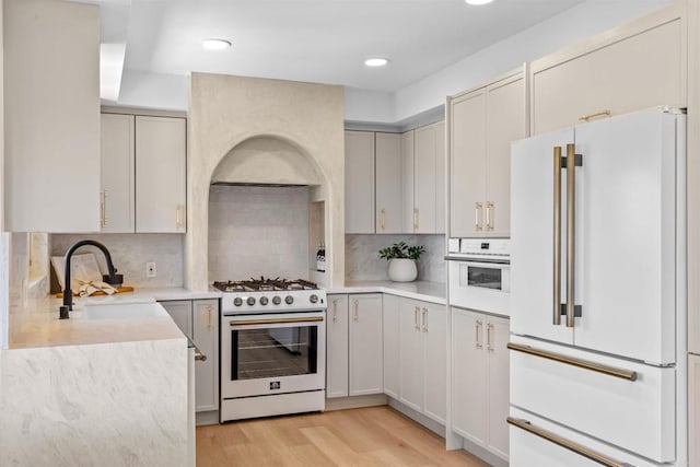 5740 Daffodil Ln, San Diego, CA 92120 - kitchen with white appliances, a sink, light wood-style flooring, light countertops, and backsplash