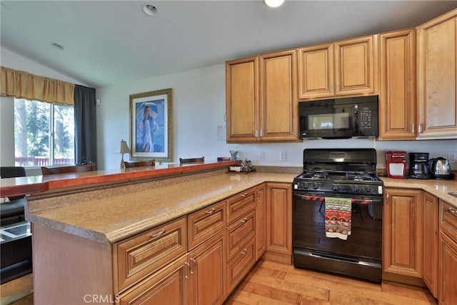 kitchen featuring black appliances, lofted ceiling, a peninsula, light wood-style flooring, and light countertops