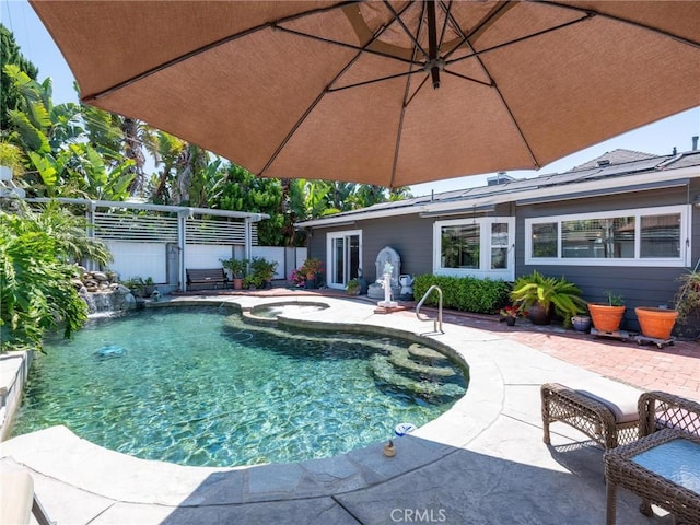 view of pool with a patio area and a pool with connected hot tub