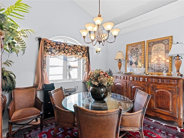 dining space featuring a chandelier and lofted ceiling
