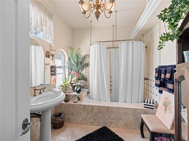 full bathroom featuring a chandelier, tiled shower / bath, and tile patterned floors
