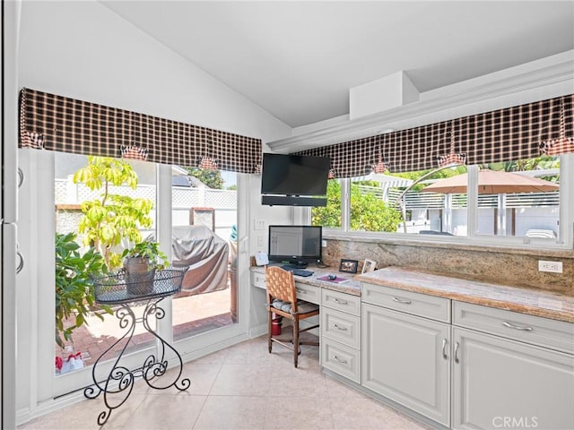 office area featuring vaulted ceiling, plenty of natural light, and light tile patterned flooring