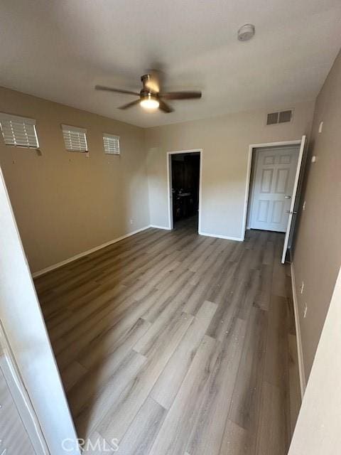 31256 Taylor Ln, Temecula, CA 92592 - unfurnished bedroom with baseboards, wood finished floors, and a ceiling fan