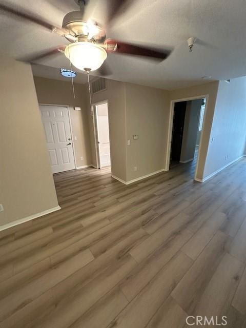 31256 Taylor Ln, Temecula, CA 92592 - unfurnished room with baseboards, a ceiling fan, and wood finished floors