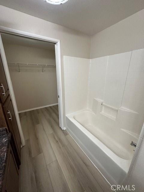 31256 Taylor Ln, Temecula, CA 92592 - bathroom with wood finished floors, a walk in closet, and baseboards