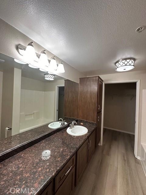 31256 Taylor Ln, Temecula, CA 92592 - full bath featuring wood finished floors, a textured ceiling, and vanity