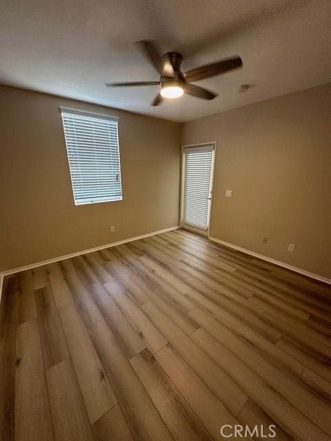 31256 Taylor Ln, Temecula, CA 92592 - unfurnished room featuring baseboards, wood finished floors, ceiling fan, and plenty of natural light