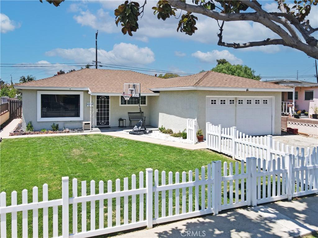 9111 Morrill Ave, Santa Fe Springs, CA 90670 - ranch-style home with stucco siding, a garage, and a shingled roof
