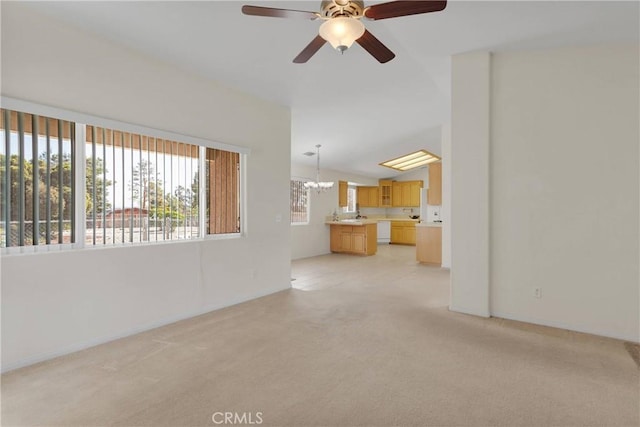 19115 Seneca, Apple Valley, CA 92307 - unfurnished living room featuring light carpet, a ceiling fan, a chandelier, vaulted ceiling, and baseboards
